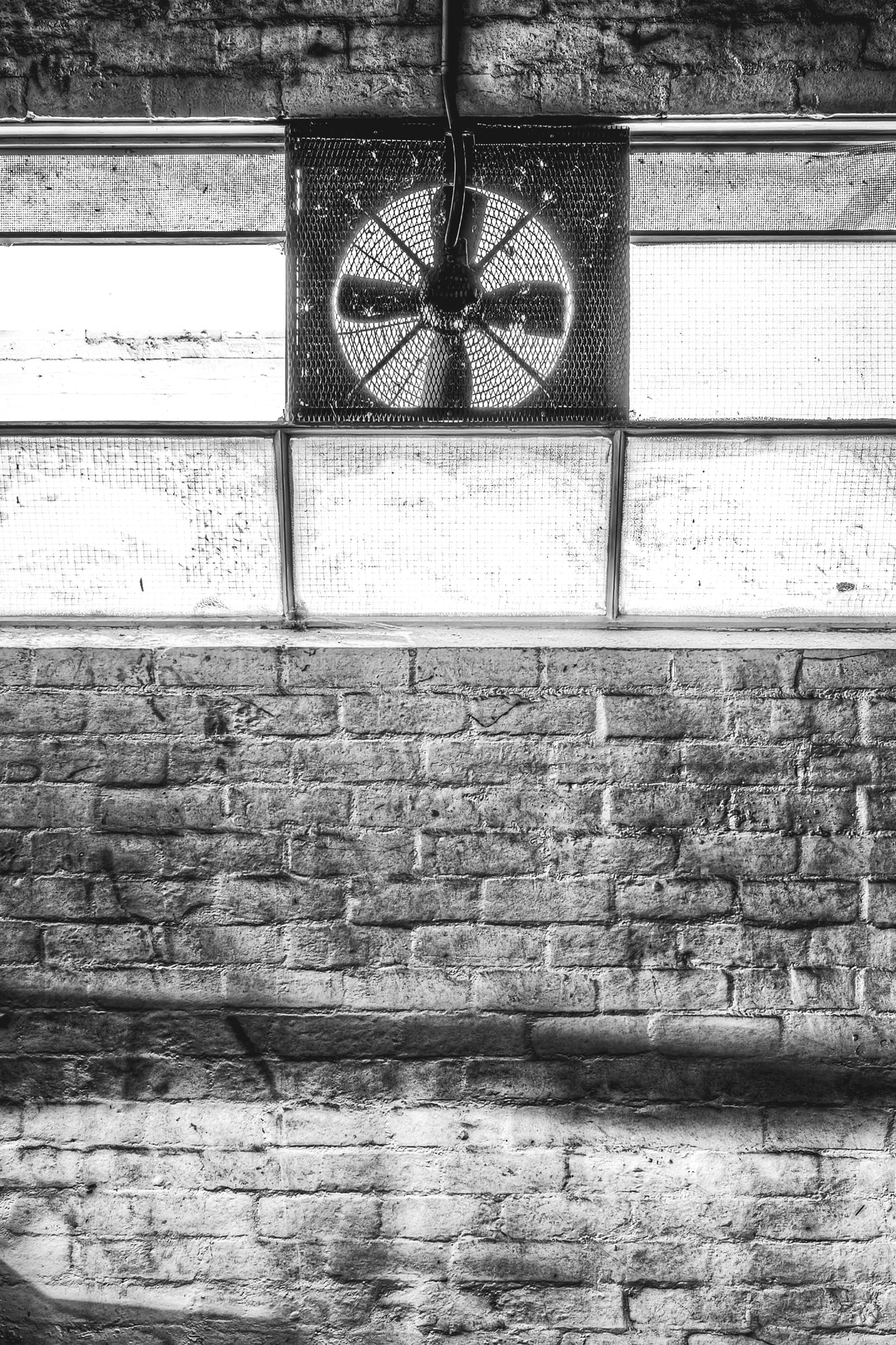 Exhaust Fan at Abandoned Shoe Factory, inside the abandoned shoe factory, a heavy industrial exhaust fan dominates a grimy.