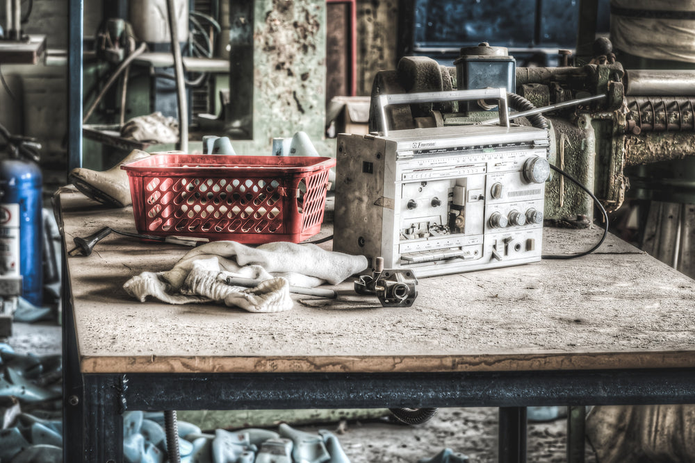 Radio at Abandoned Shoe Factory, a former workers old radio on one at the work benches.