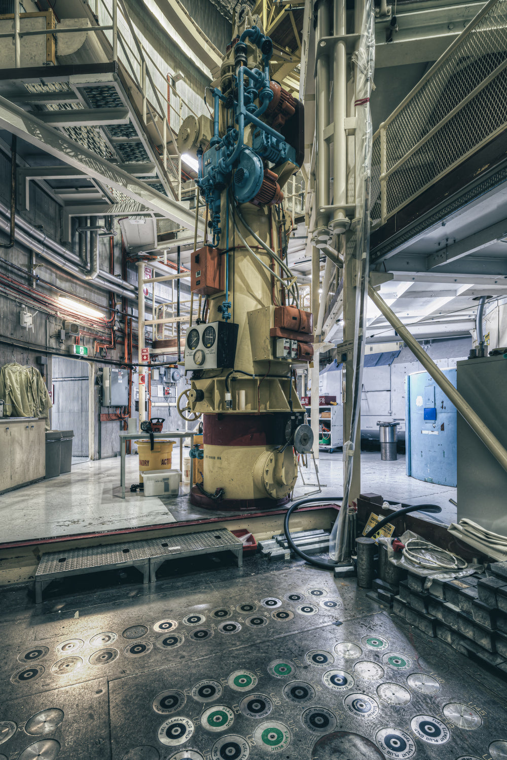 Fuel Storage and Flask at ANSTO HIFAR, a heavy cylindrical fuel handling mechanism rises from floor level through multiple.