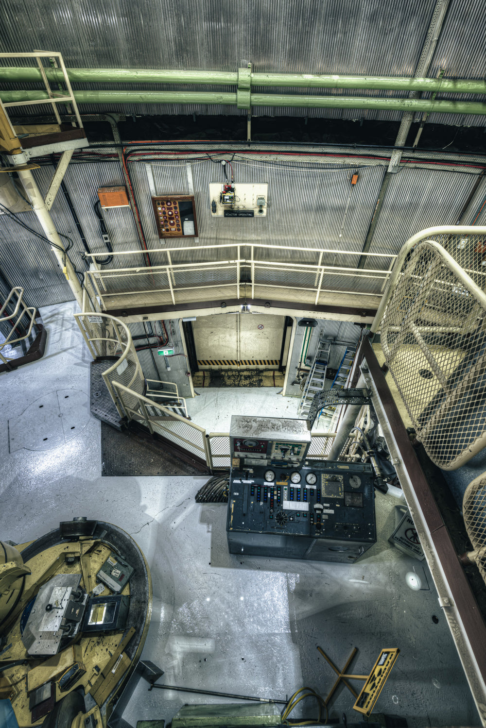Mezzanine to Vehicle Airlock at ANSTO HIFAR, green coolant pipes run beneath a corrugated steel ceiling.