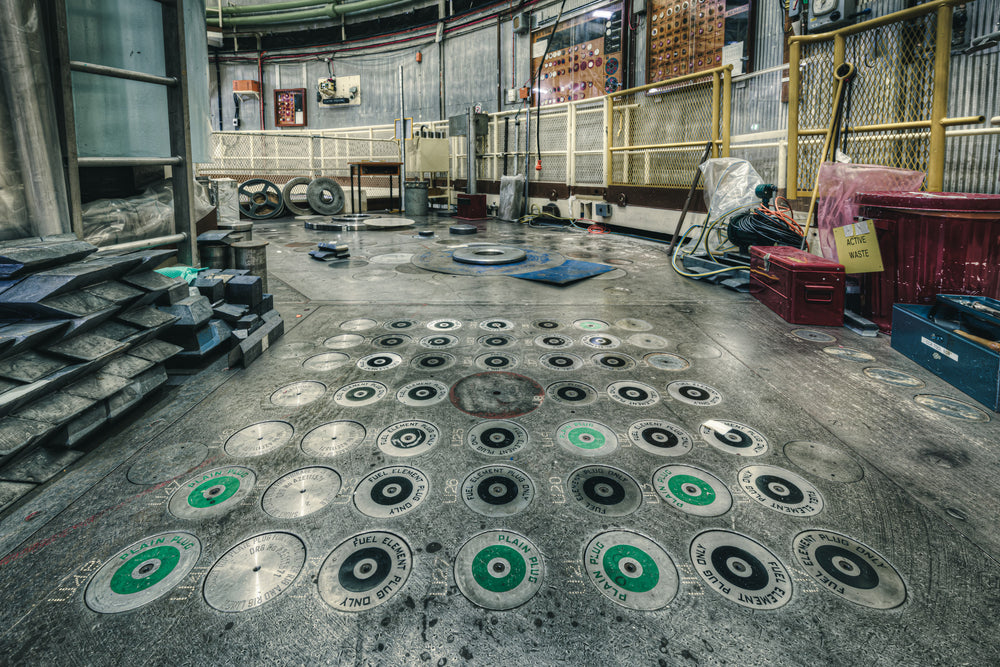 No 1 Storage Block at ANSTO HIFAR, dozens of circular plugs are set into the reactor's charge face, each stamped "FUEL.