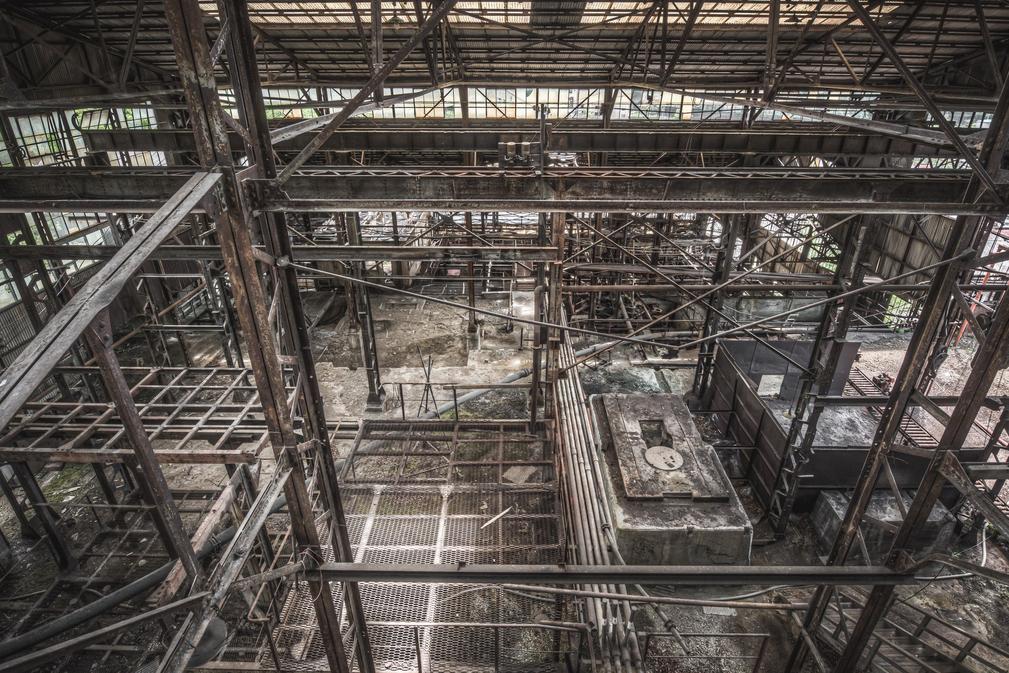 Looking Down at Ashio Copper Mine, steel framework fills the entire frame, viewed from an elevated gantry looking down.