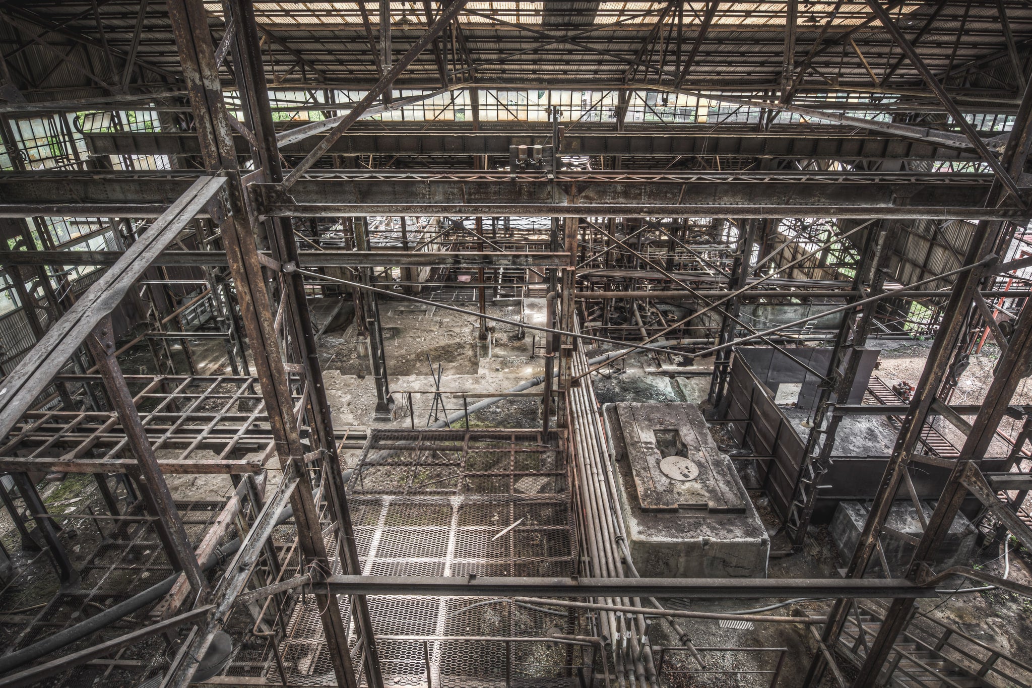Looking Down at Ashio Copper Mine, steel framework fills the entire frame, viewed from an elevated gantry looking down.