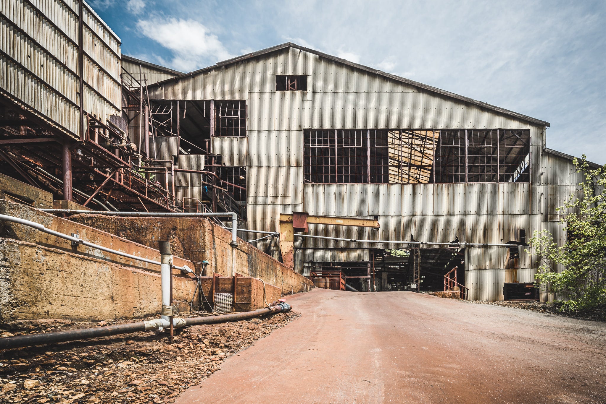 Refinery at Ashio Copper Mine, corrugated iron cladding covers the refinery building in heavy, weathered sheets.