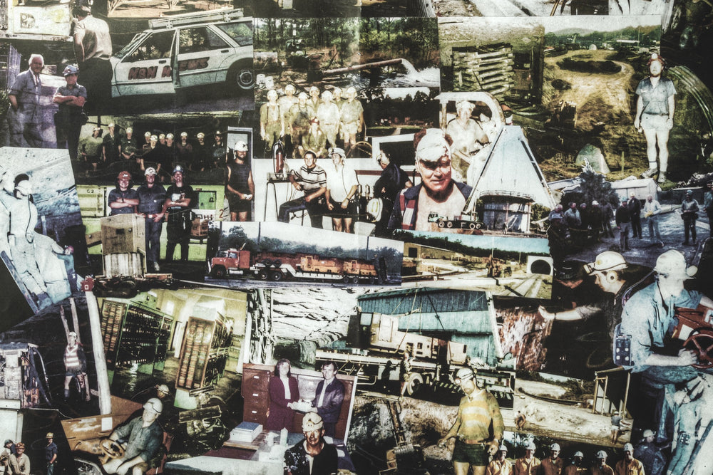 A wall collage of photographs from Awaba Colliery showing workers in hard hats, a white NSW Mine station wagon, group shots at the pit, and a red semi-trailer carrying heavy equipment.