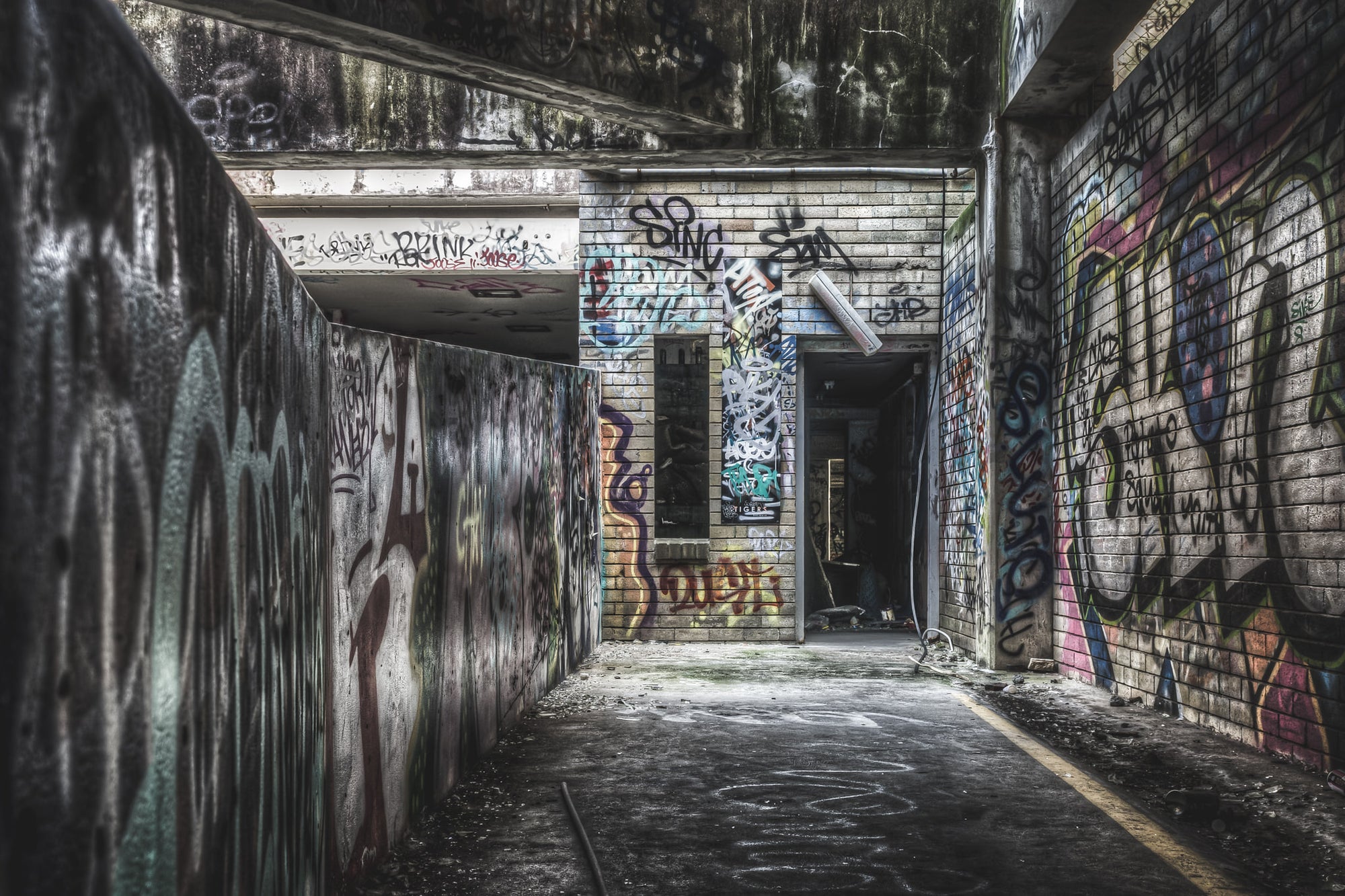 Fire Exit at Balmain Leagues Club, a low concrete ceiling presses down over a corridor deep inside the building.