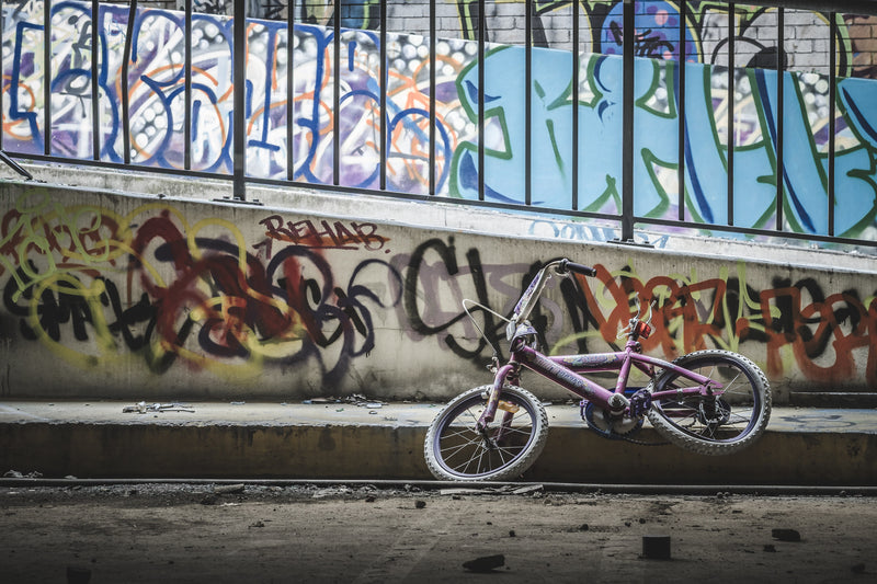 A pink child's bicycle, its frame marked with the characters '2cute', leans against a concrete wall at the former Balmain Leagues Club in Rozelle.