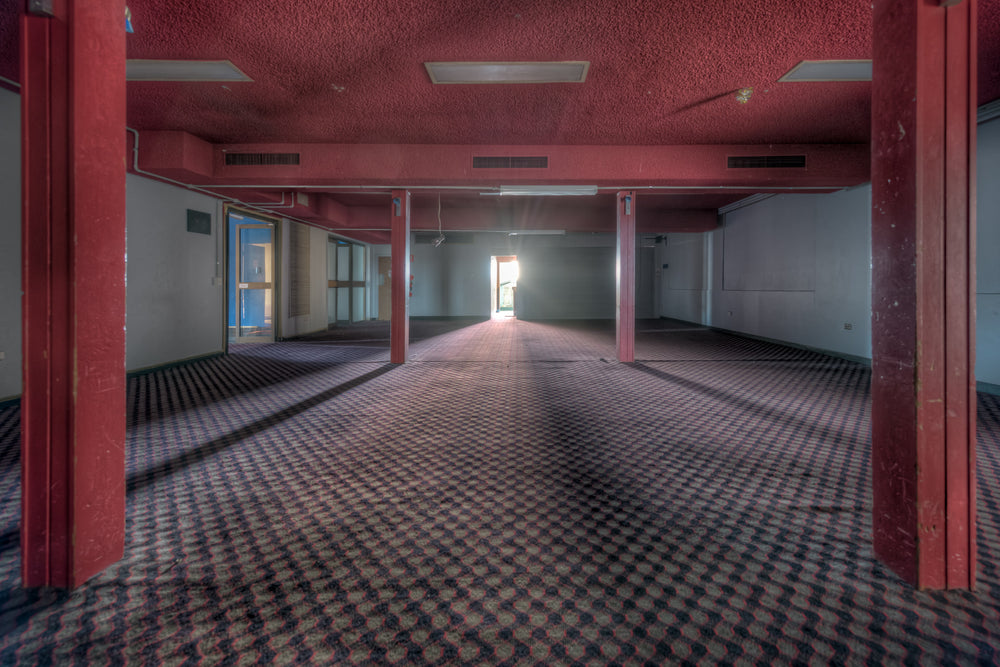 Bistro Pylons at Bankstown RSL, red columns run floor to ceiling through a wide, empty function room.