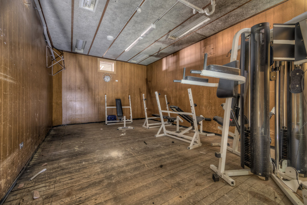 Gym at Bankstown RSL, wood-panelled walls line a low-ceilinged basement room.