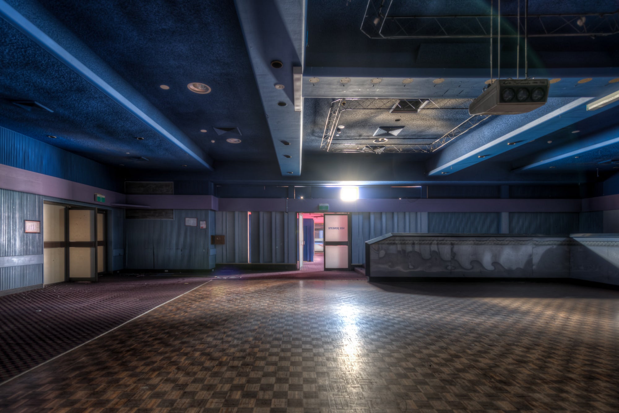 Nightclub Entrance at Bankstown RSL, a chequerboard dance floor stretches across the room, its surface slick under a single.