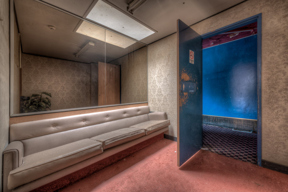 Powder Room at Bankstown RSL, a long vinyl banquette lines the wall beneath a wide mirror.