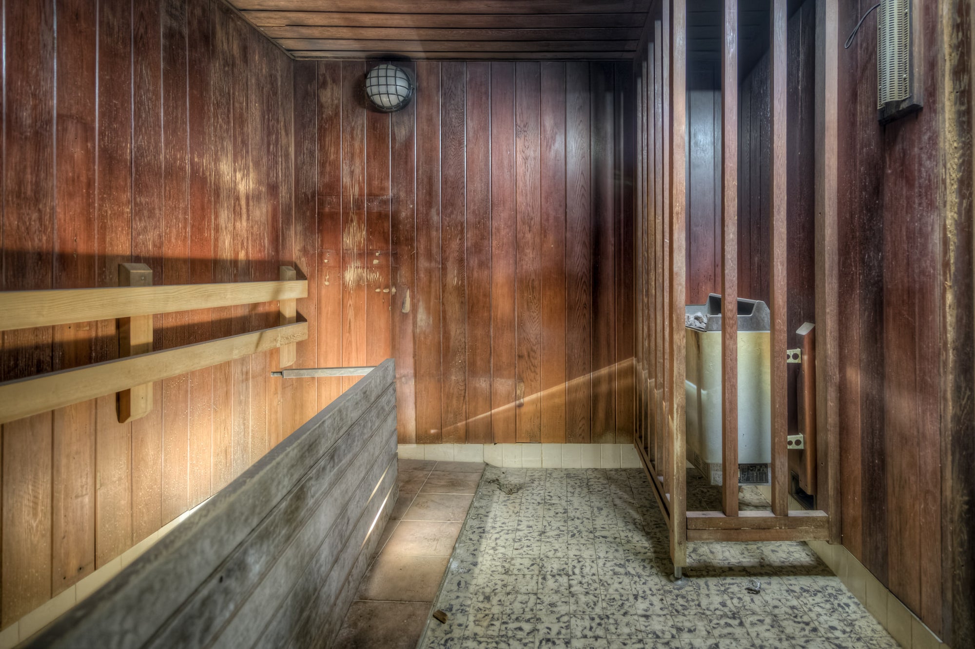 Sauna at Bankstown RSL, cedar-lined walls darken with moisture stains where the grain has swollen and split.