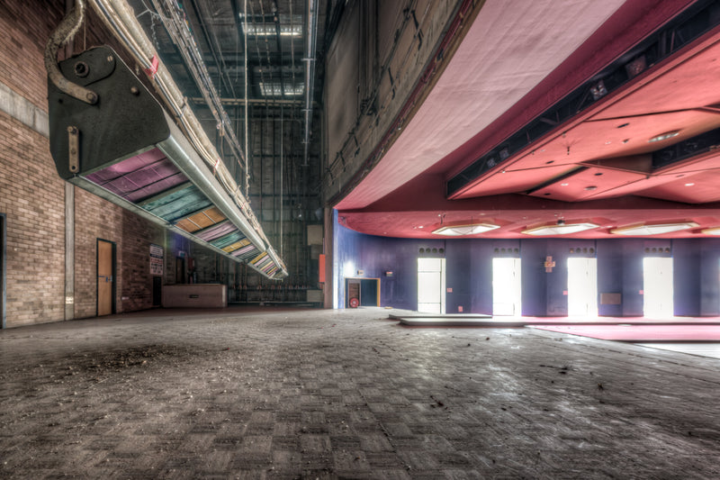 Multicoloured light panels in pink, green and yellow hang the length of a corridor at the old Bankstown RSL clubhouse, their faded colours holding against the deterioration below.