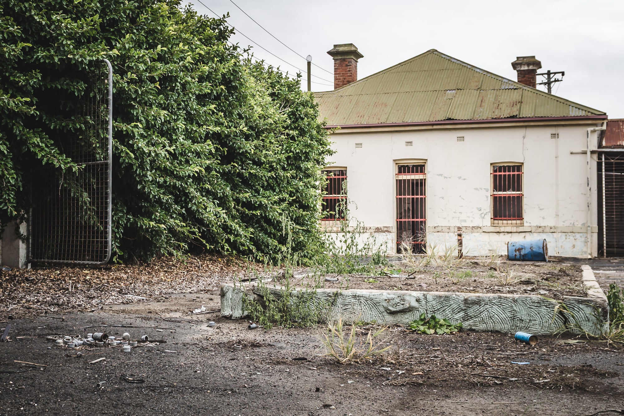 Admin at Bathurst Gasworks, a single-storey rendered building sits behind a stripped forecourt.