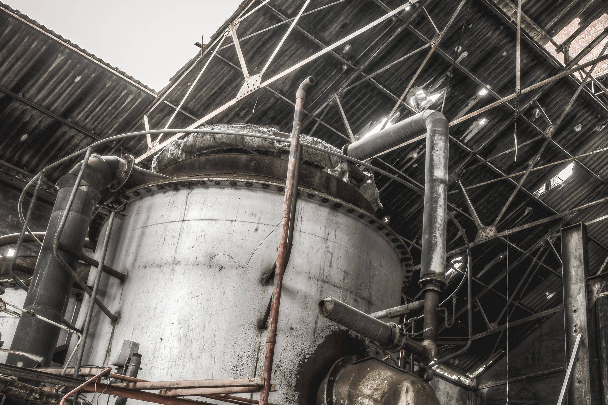 Purifier Shed Roof at Bathurst Gasworks, a large cylindrical vessel fills the frame, its steel skin streaked with grime.