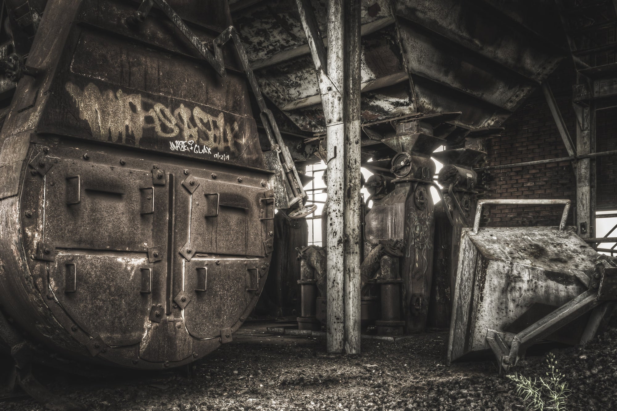 Top Of Retort at Bathurst Gasworks, a cylindrical retort vessel dominates the left of frame, its riveted steel face scaled.