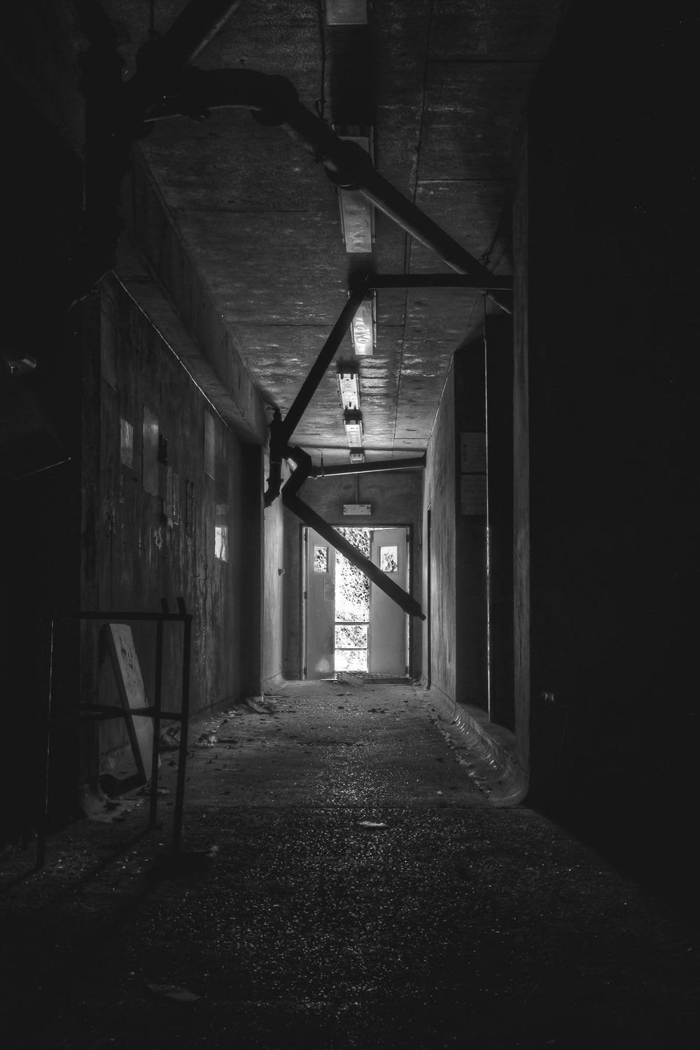 Dark Hallway at Blayney Abattoir, a narrow concrete corridor runs deep into shadow.