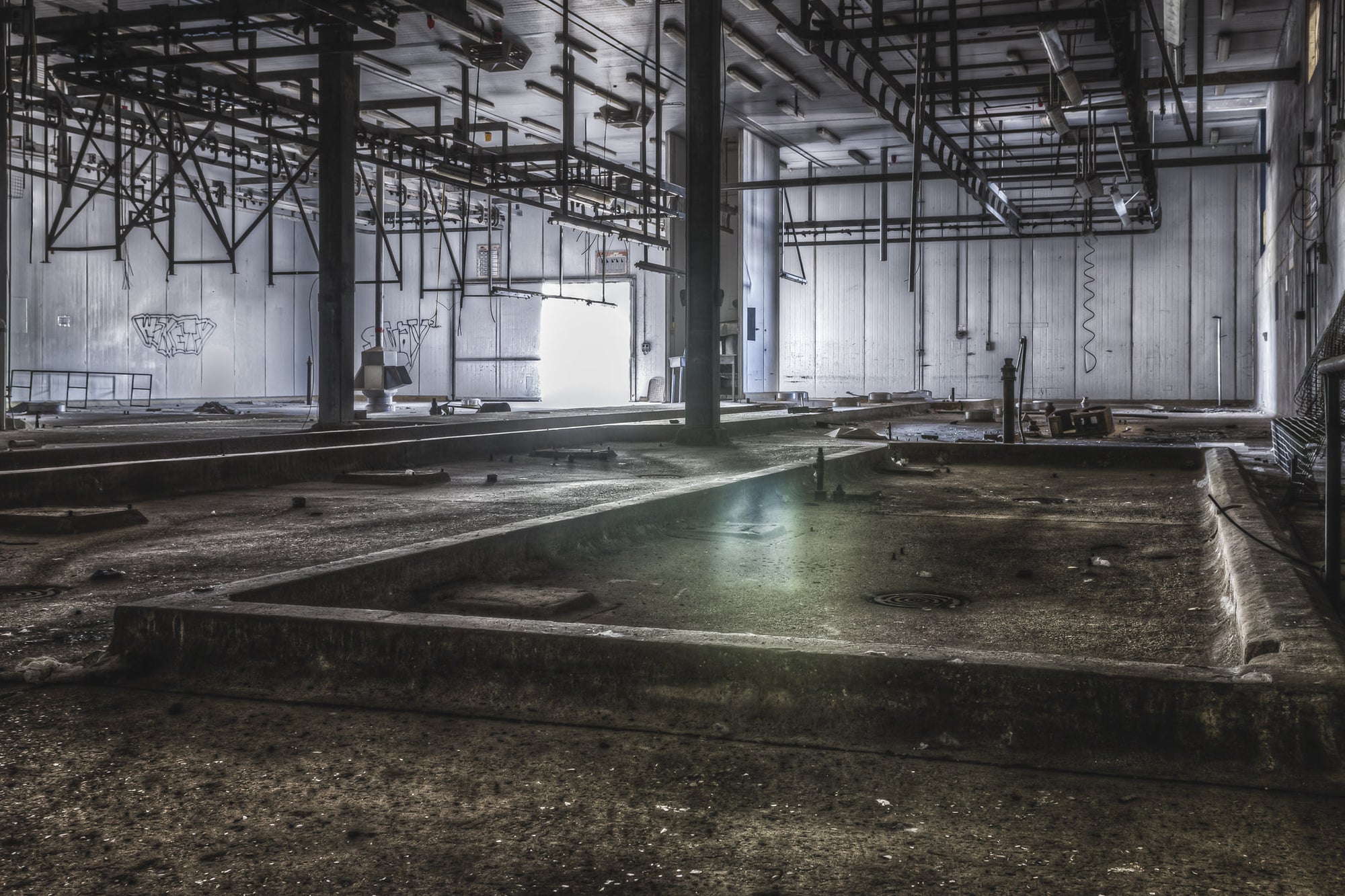 Kill Floor at Blayney Abattoir, steel columns rise from a concrete floor divided into shallow bays and drainage channels.