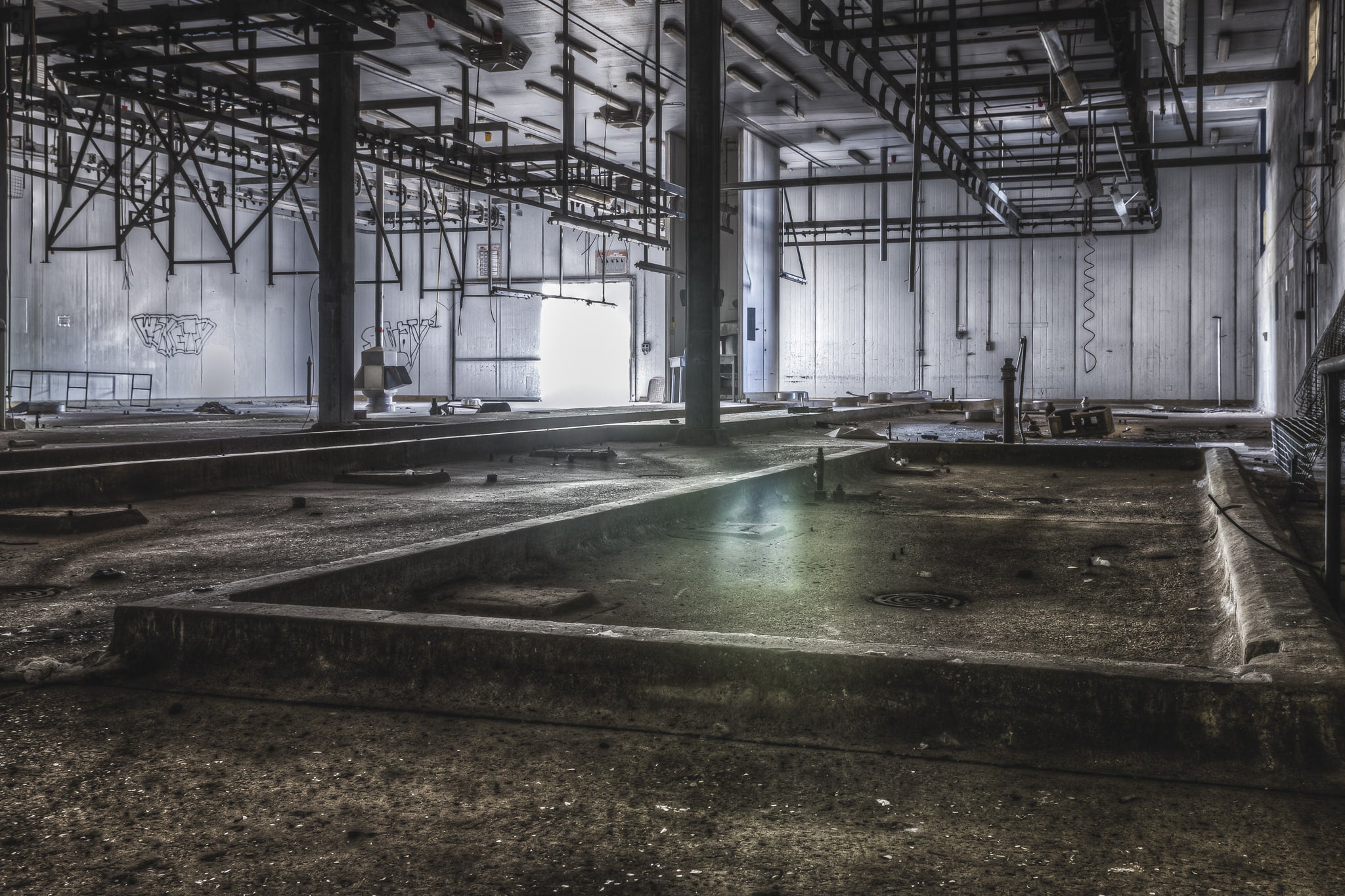 Kill Floor at Blayney Abattoir, steel columns rise from a concrete floor divided into shallow bays and drainage channels.