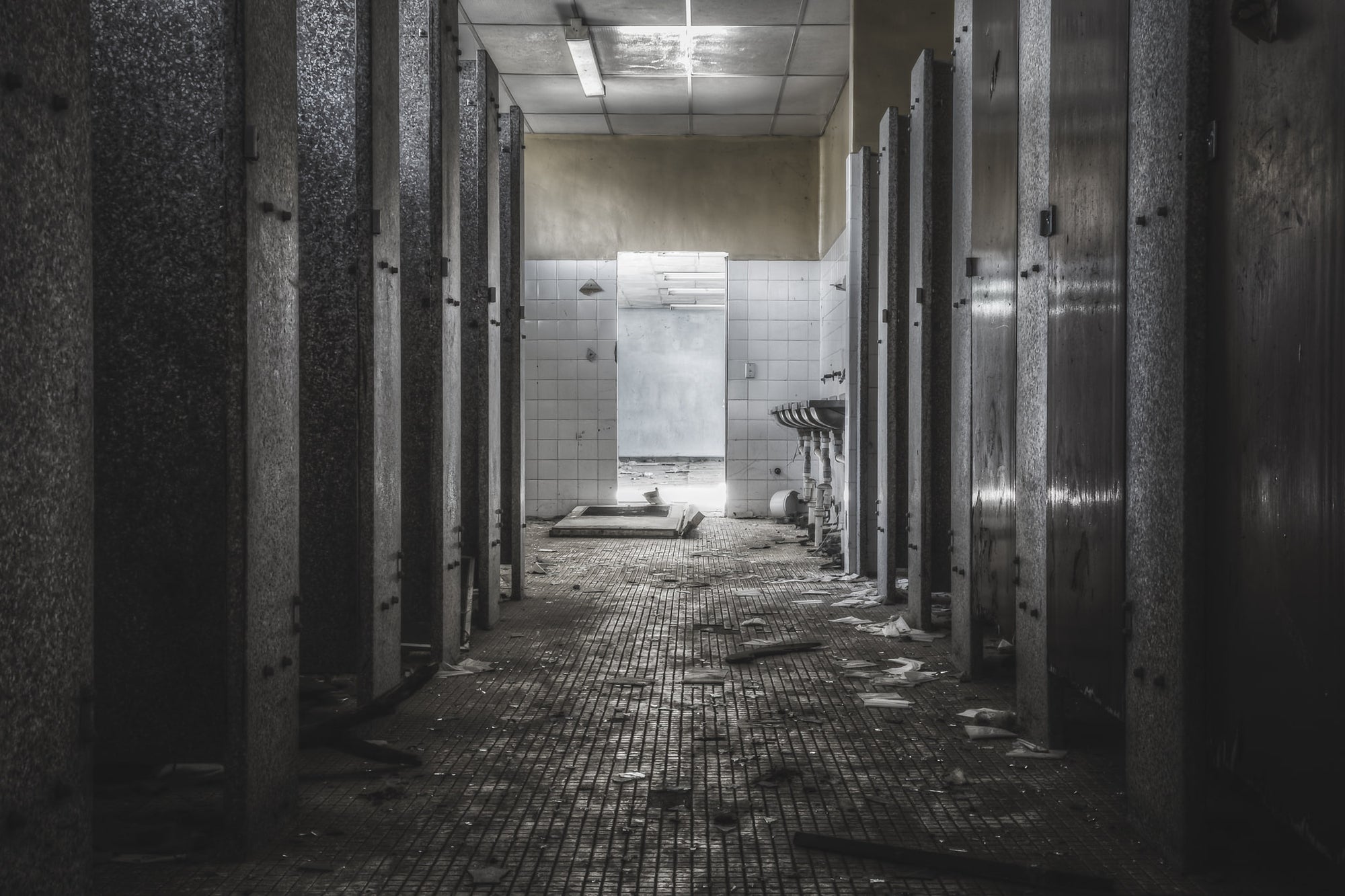 Toilet Block at Blayney Abattoir, stalls line both sides of this abandoned toilet block, their doors still mostly in place.