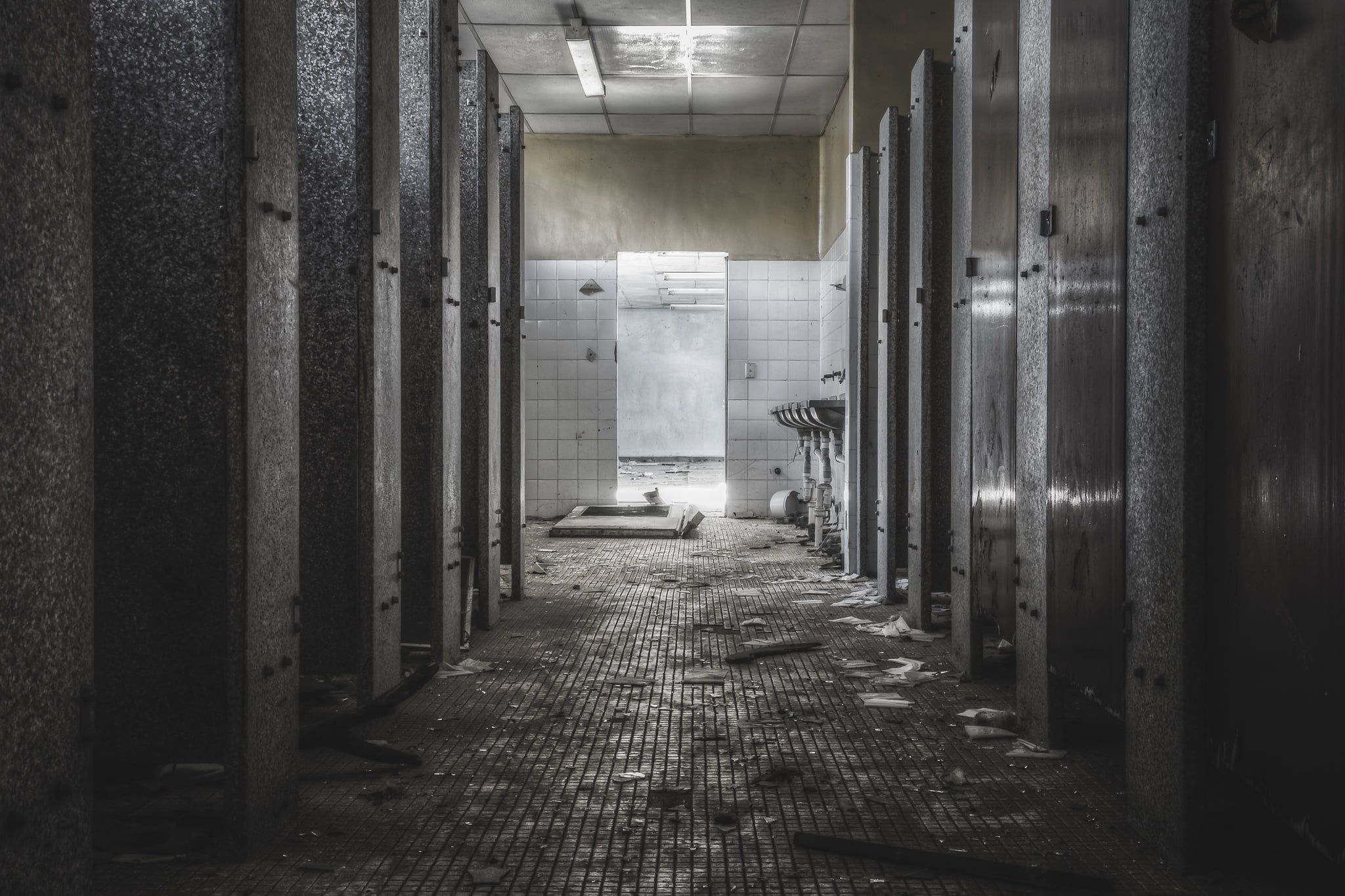 Toilet Block at Blayney Abattoir, stalls line both sides of this abandoned toilet block, their doors still mostly in place.