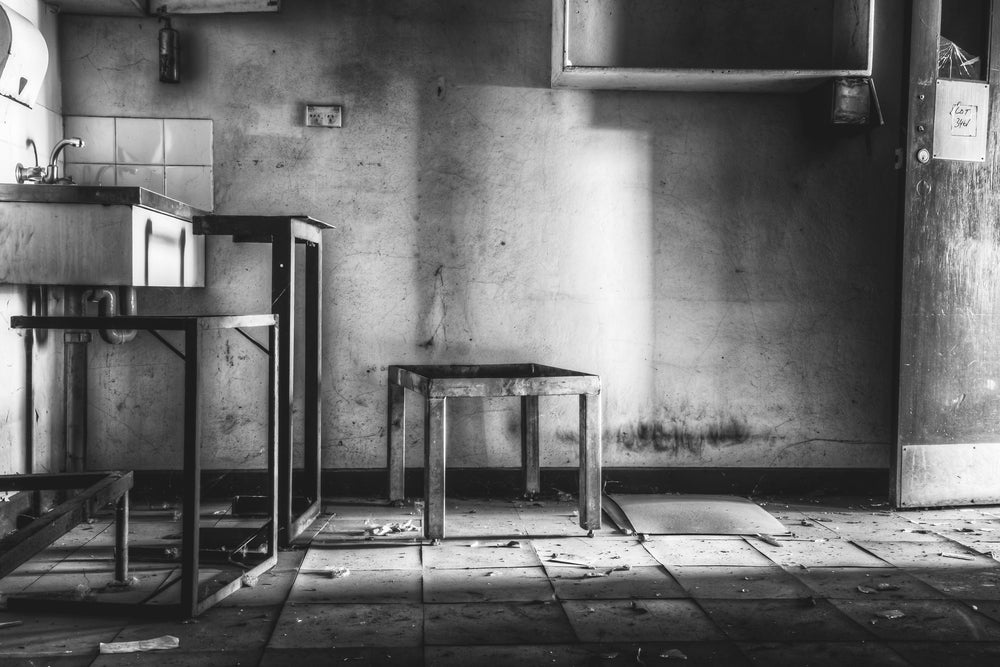 Wash Room at Blayney Abattoir, a shaft of light falls through an open window onto cracked floor tiles.