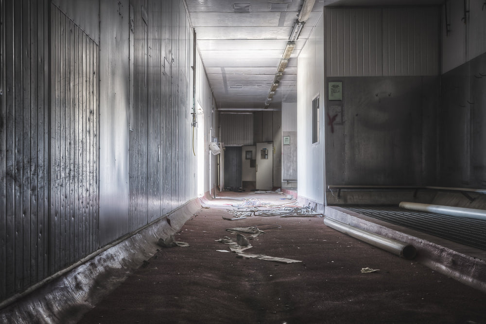 Washing Area at Blayney Abattoir, a corridor opens into a wider room where the floor sits dark and bare.