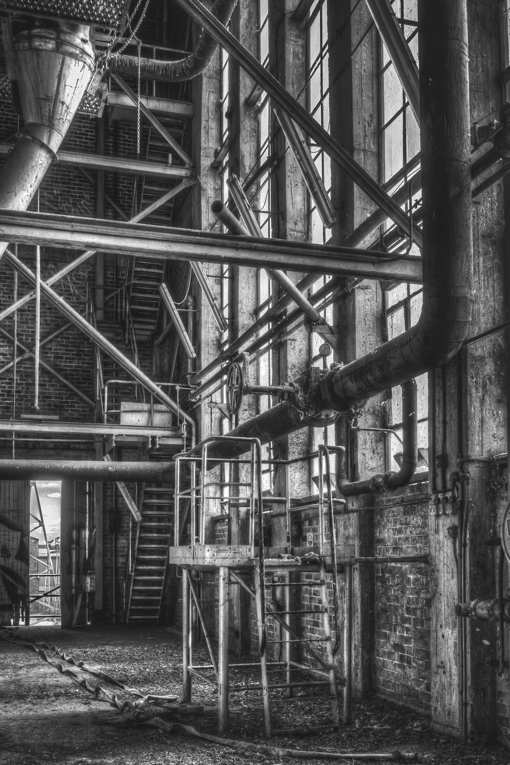 BW Windows at Bradmill Denim, steel beams and steam pipes climb the full height of the boiler house wall.