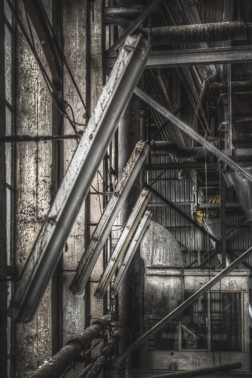 Lights at Bradmill Denim, steel beams cut diagonally across the frame, crossing pipes and structural columns inside.