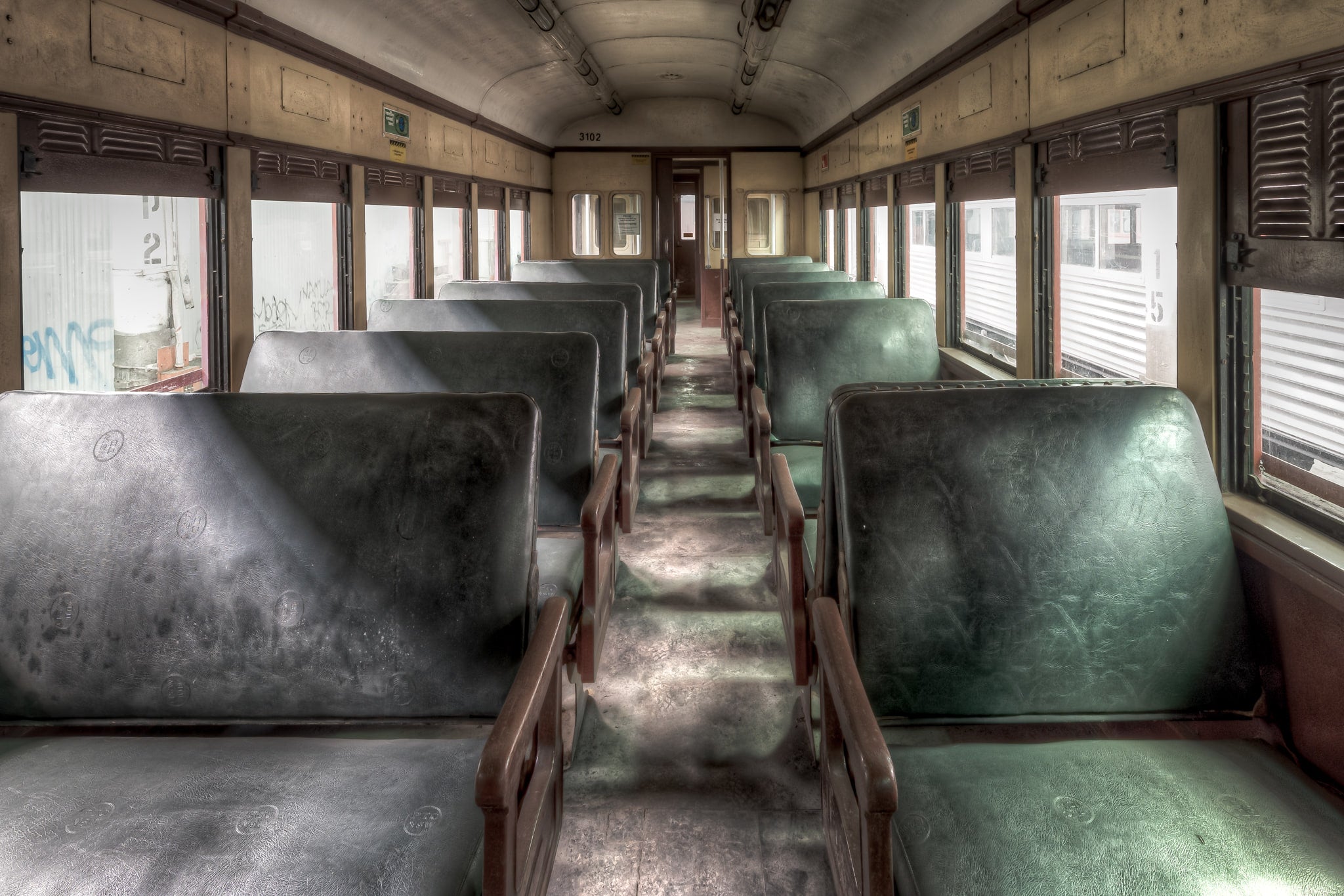 3102 Main Passenger Car at Eveleigh Paint Shop, green vinyl seats run in two rows down the centre aisle of Car 3102.