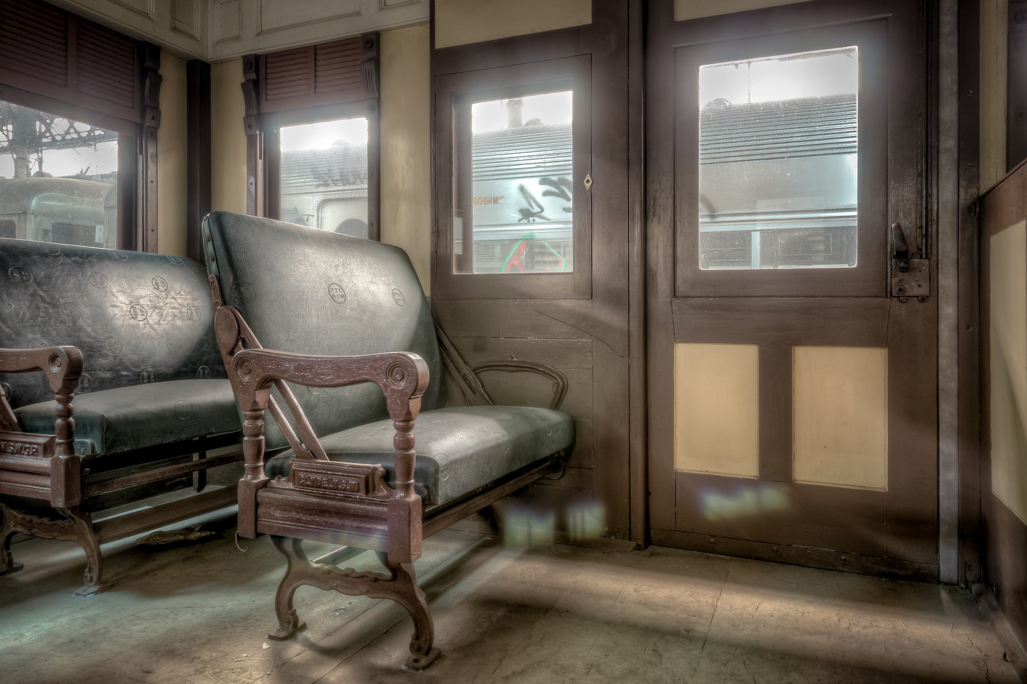 Genuine Leather Seats at Eveleigh Paint Shop, green leather seats line the interior of a decommissioned railway carriage.