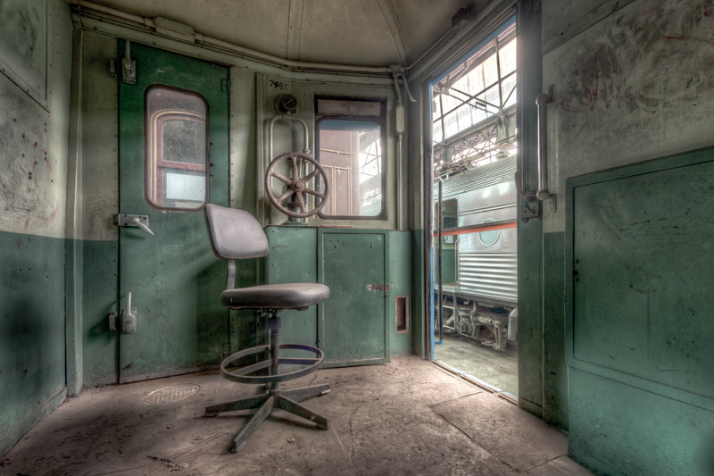 Guards Compartment at Eveleigh Paint Shop, a drafting chair sits on the gritty floor of the guard's compartment inside car C7485.