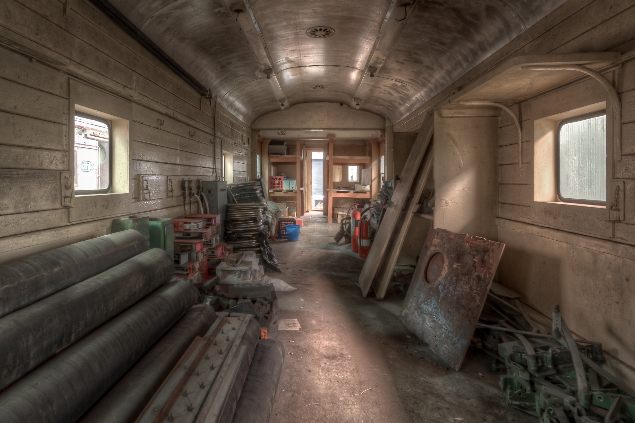 Parcel Van 3903 at Eveleigh Paint Shop, inside the carriage, timber-panelled walls curve up to a barrel-vaulted ceiling coated in grey grime.