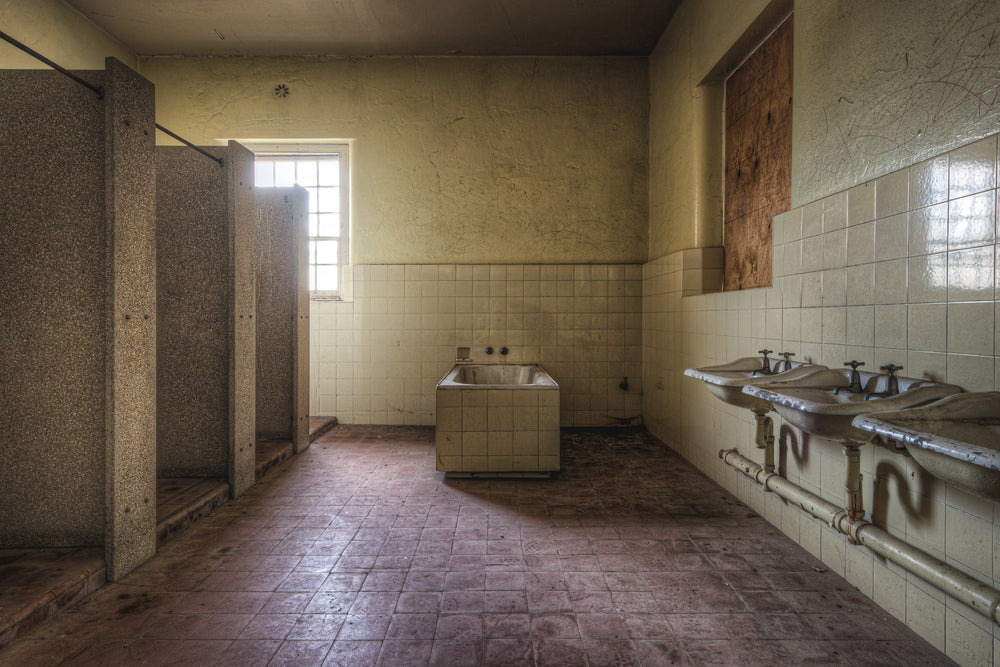 Bathroom at Female Ward 9 & 10, a communal bathroom stripped back to its fixtures.
