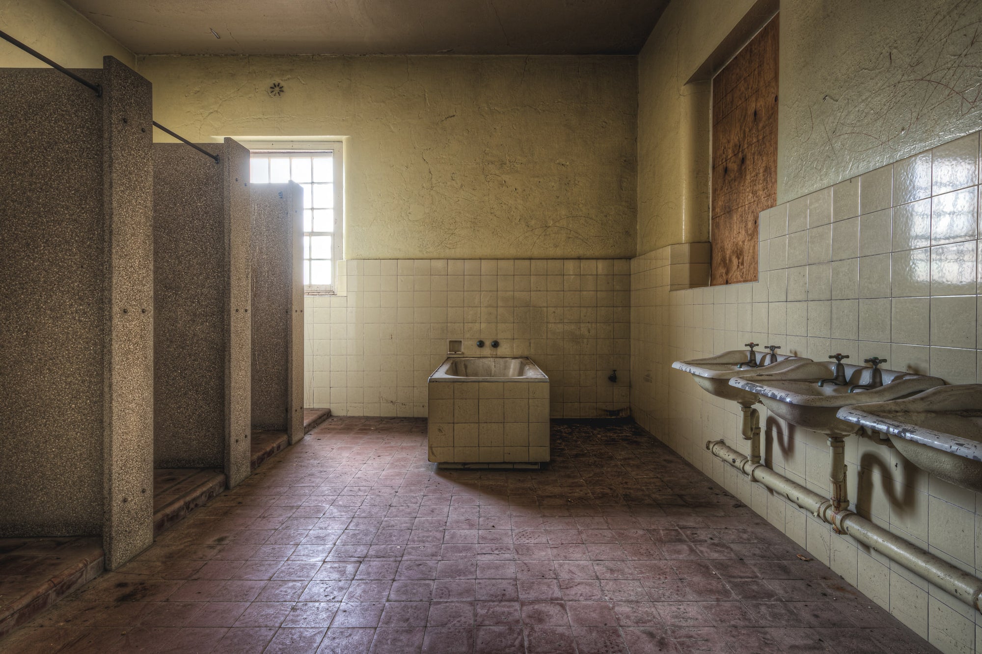 Bathroom at Female Ward 9 & 10, a communal bathroom stripped back to its fixtures.