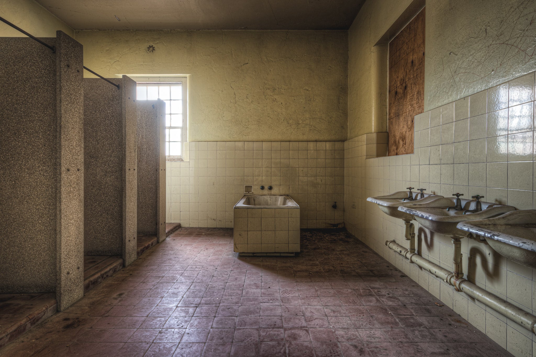 Bathroom at Female Ward 9 & 10, a communal bathroom stripped back to its fixtures.
