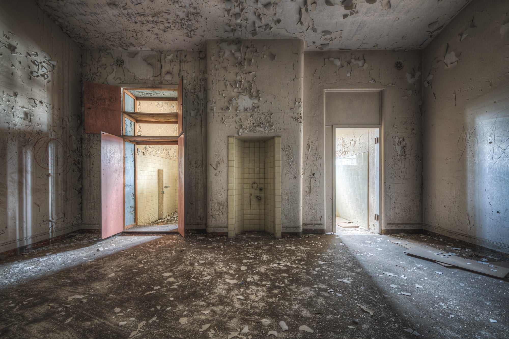 Bathrooms at Female Ward 9 & 10, paint peels from every surface.