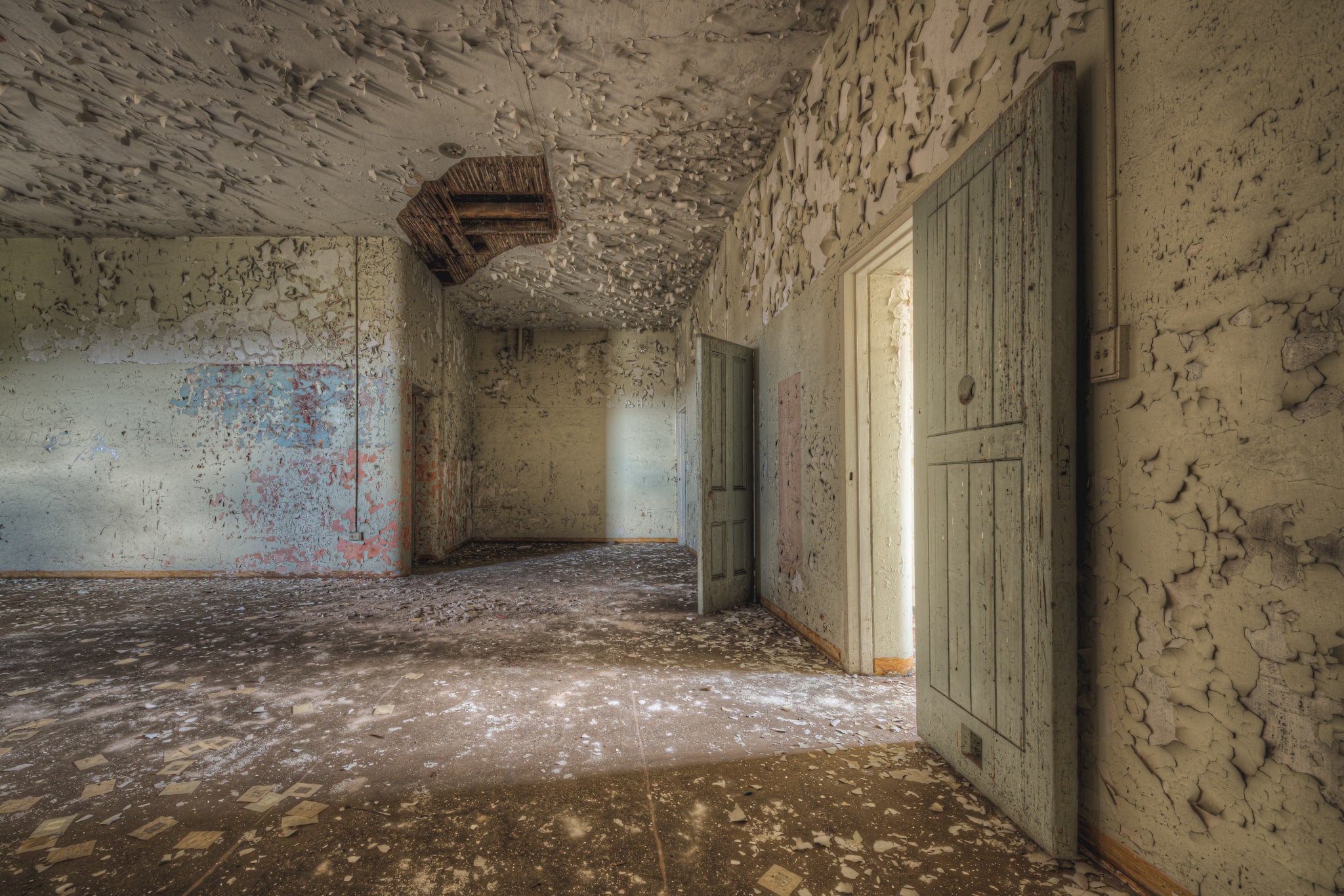 Cell Walls at Female Ward 9 & 10, paint peels from every surface in thick, curling sheets.