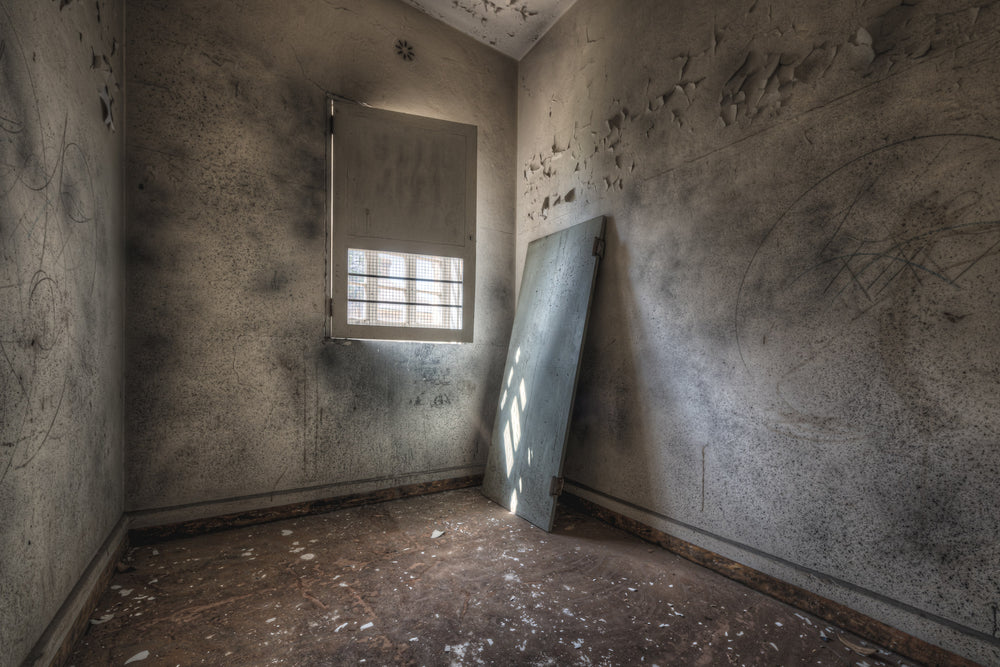 Inside Cell at Female Ward 9 & 10, a small room, bare and closed in.