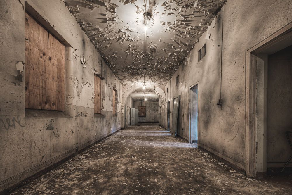 Kirkbride Cells at Female Ward 9 & 10, a corridor with patient rooms on the right under heavily peeling paint.