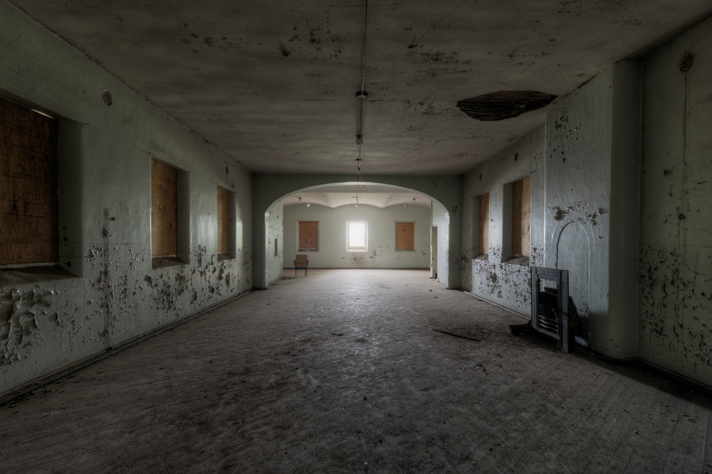 Light at the End of the Tunnel at Female Ward 9 & 10, a single unboarded window illuminating a cavernous space within.