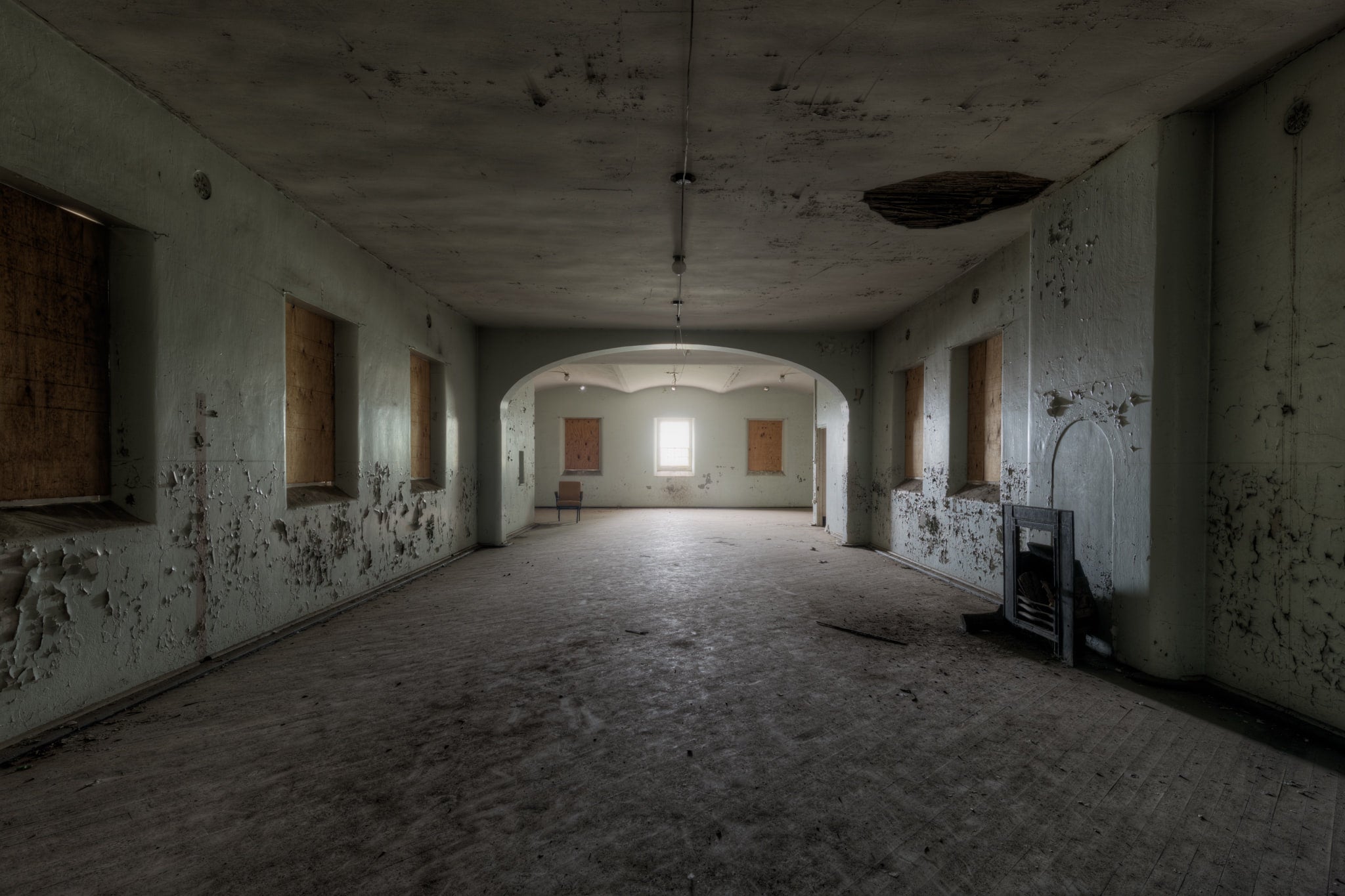 Light at the End of the Tunnel at Female Ward 9 & 10, a single unboarded window illuminating a cavernous space within.