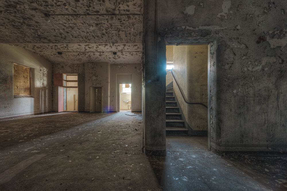 Split at Female Ward 9 & 10, a wall dividing the main area of the ward and a staircase to upper levels.