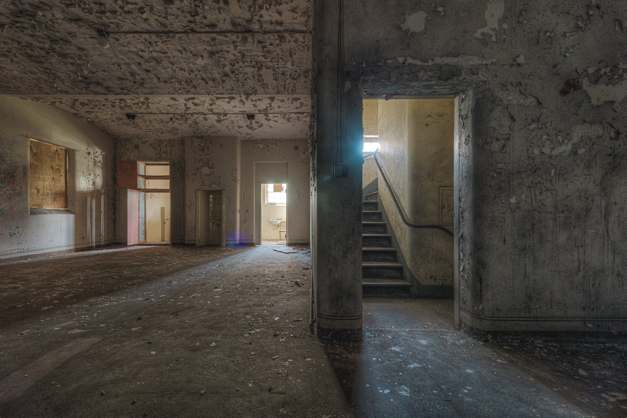 Split at Female Ward 9 & 10, a wall dividing the main area of the ward and a staircase to upper levels.