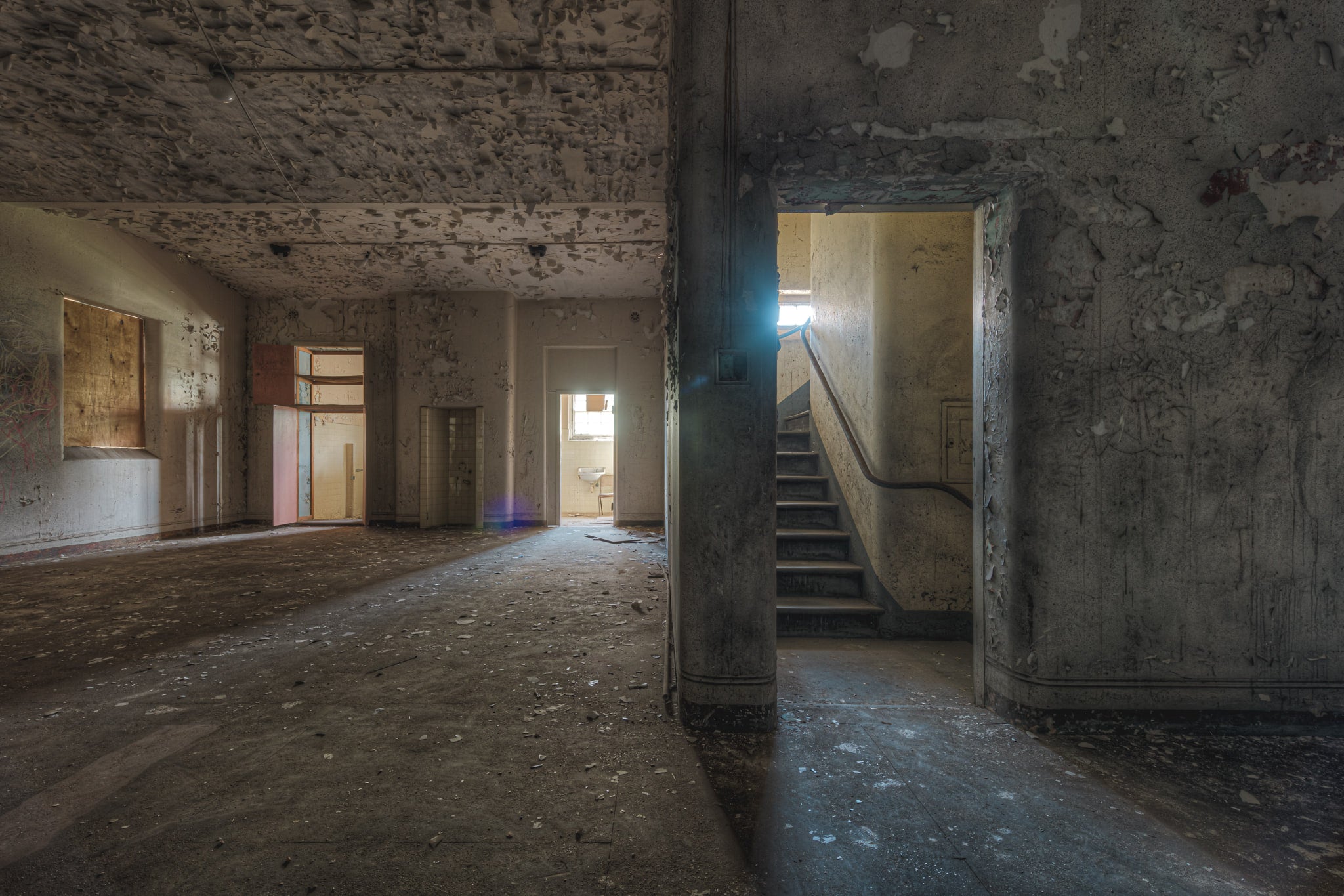 Split at Female Ward 9 & 10, a wall dividing the main area of the ward and a staircase to upper levels.