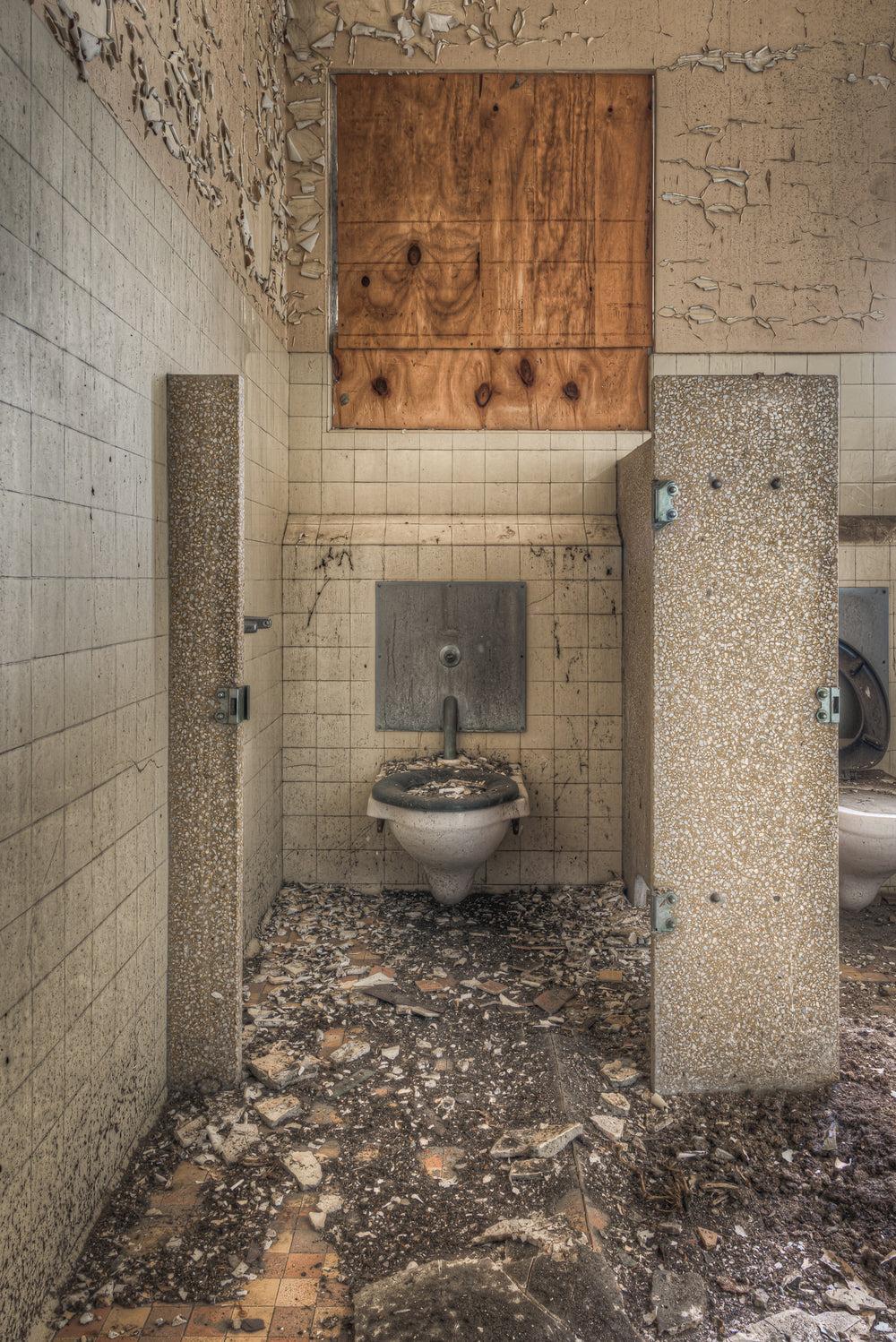 Toilet at Female Ward 9 & 10, a ceramic drinking fountain sits fixed to the tiled wall of a lavatory cubicle.