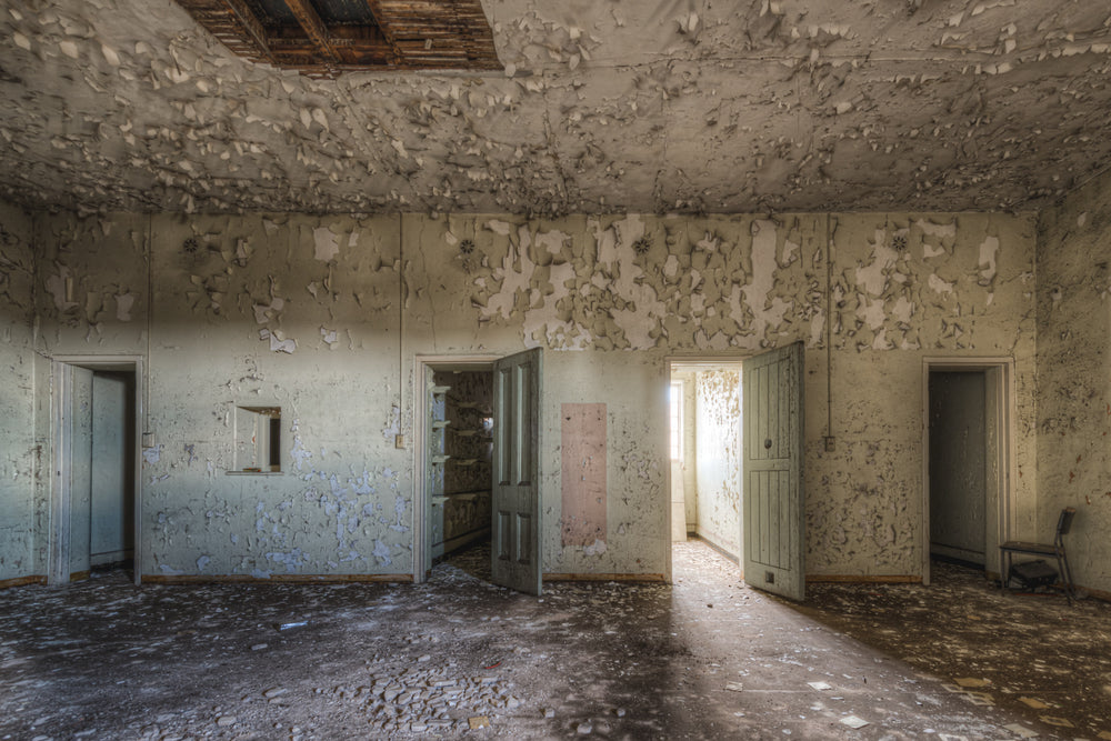 Upstairs Cells at Female Ward 9 & 10, paint peels from every surface in thick, curling sheets.