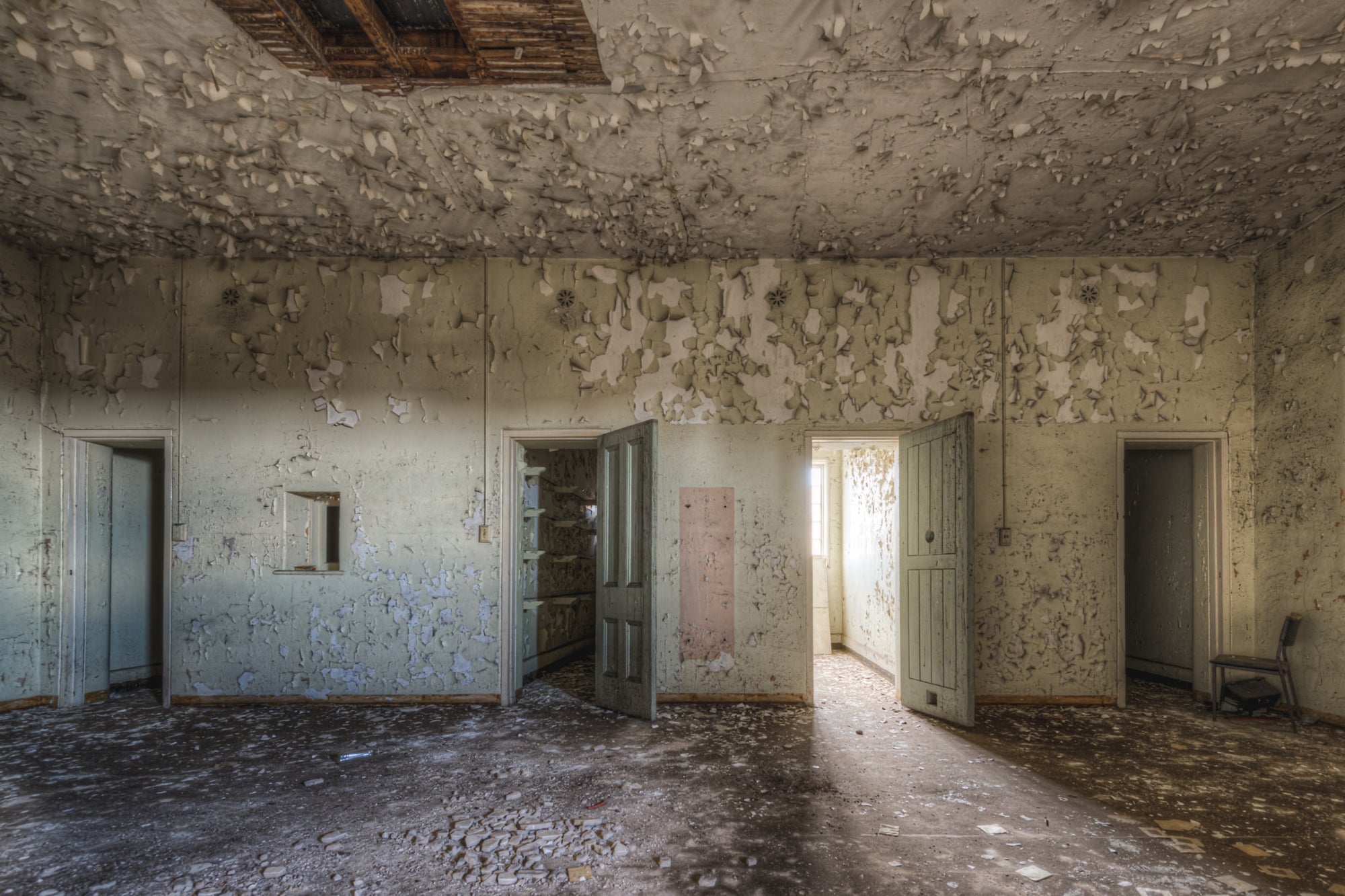 Upstairs Cells at Female Ward 9 & 10, paint peels from every surface in thick, curling sheets.