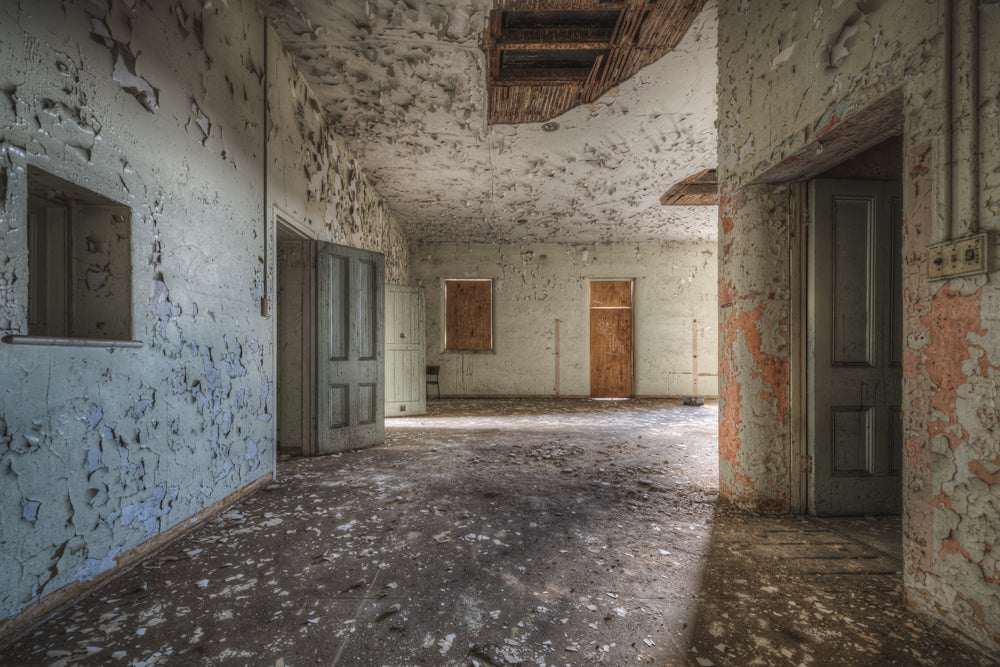 Upstairs Ward at Female Ward 9 & 10, paint peels from every surface in wide, brittle curls.