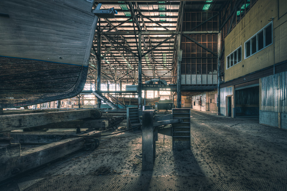 Boat Stands at Halvorsens Boat Yard, a timber hull sits raised on keel blocks inside the main construction shed.
